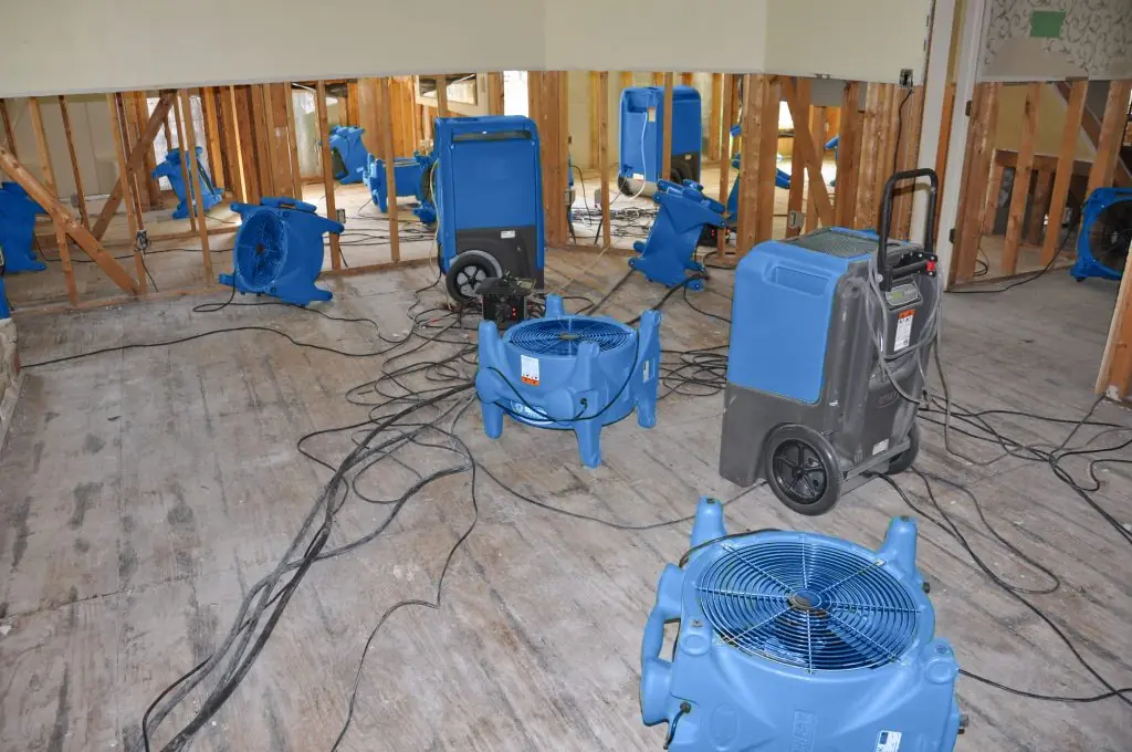 Air movers drying a gutted Winston-Salem room after major water damage